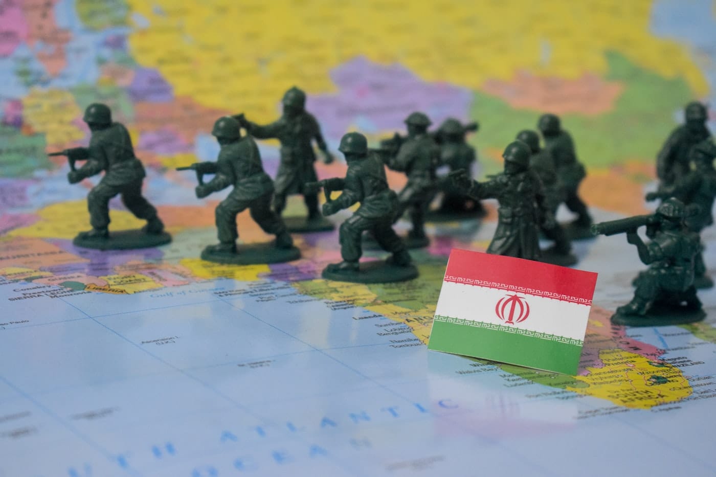 Toy soldiers on a map with iran flag