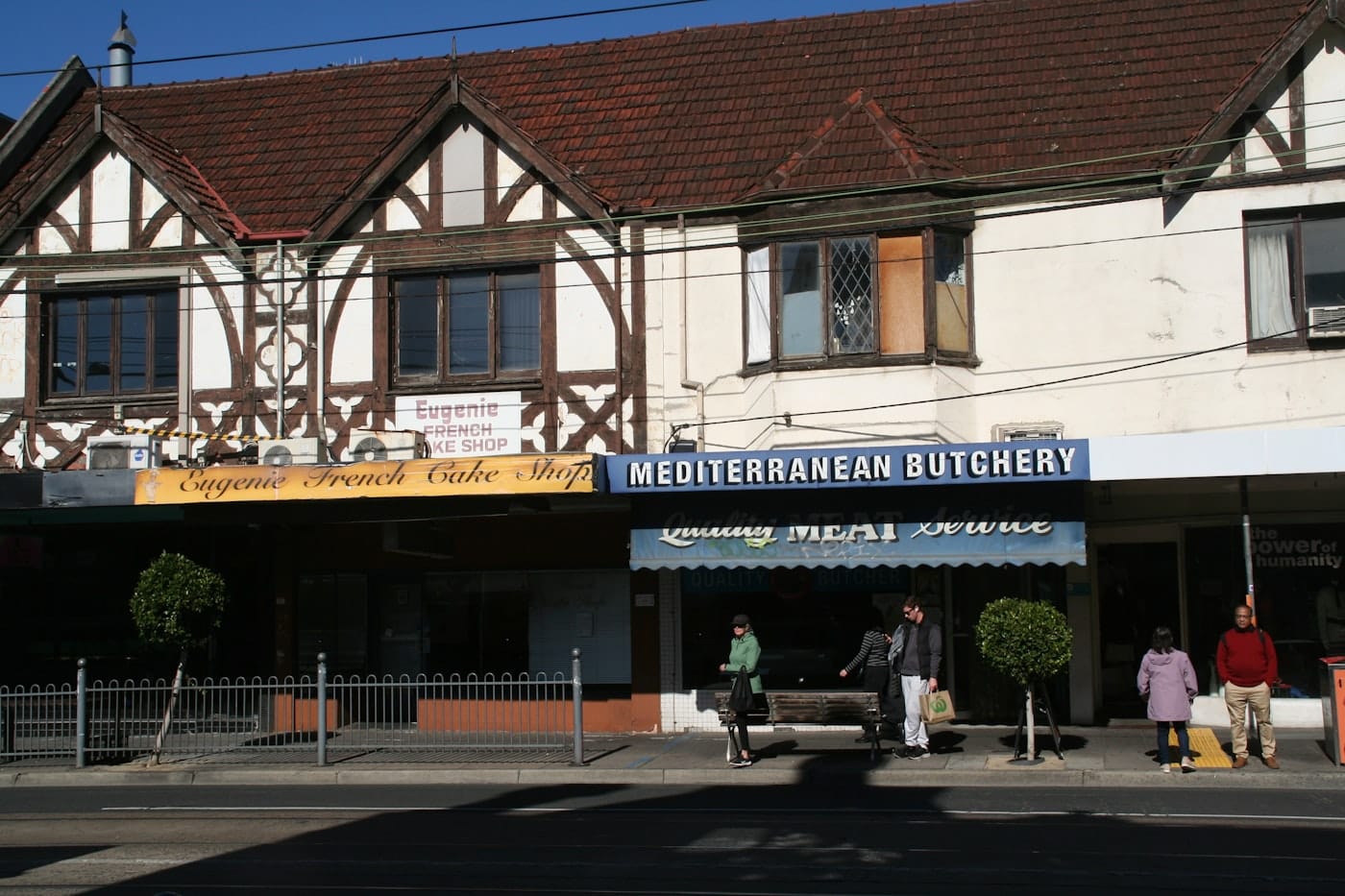 Tudor-style building with shops on street level one level